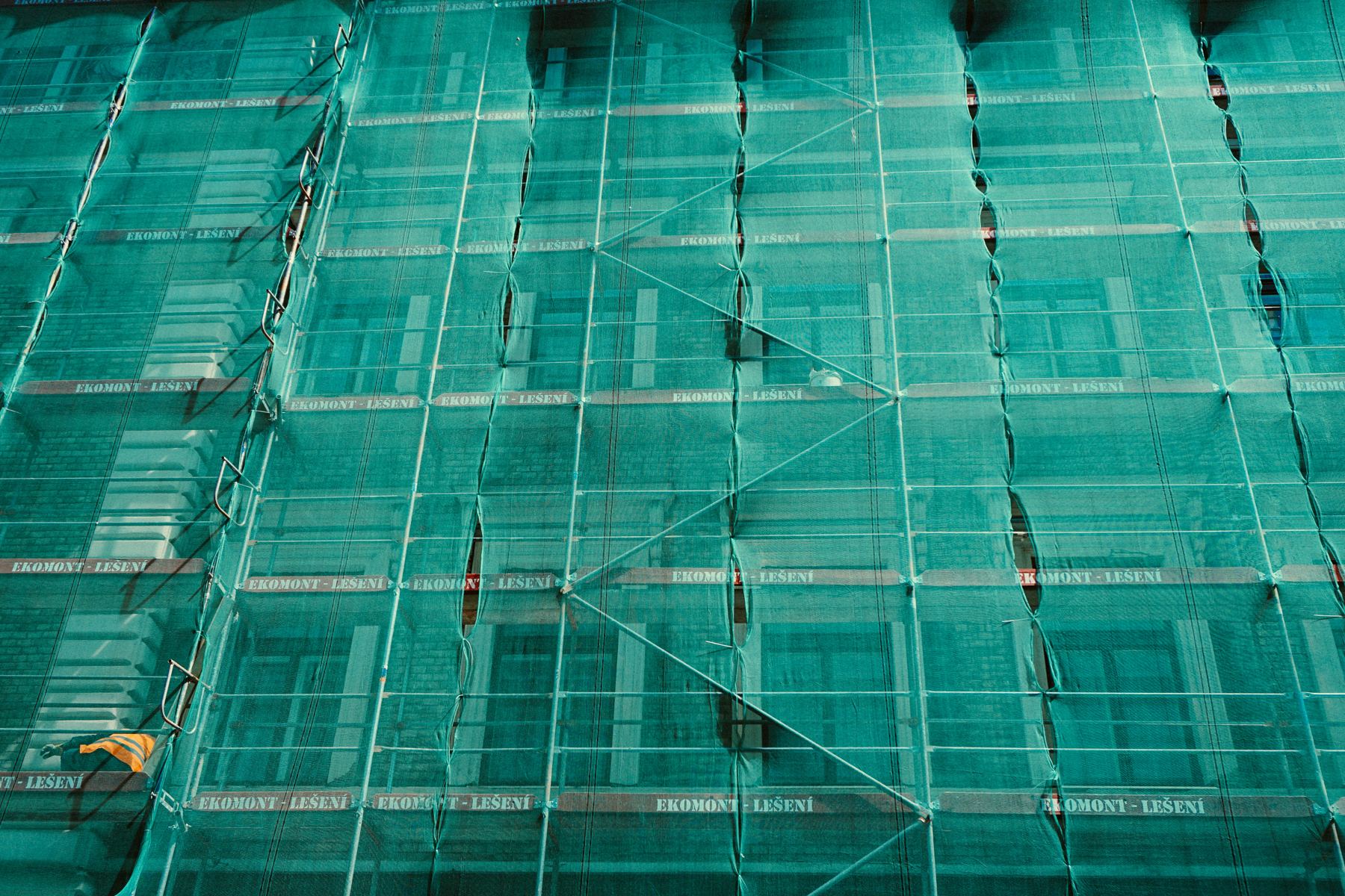 Facade covered with protective netting and scaffolding during a FISP inspection