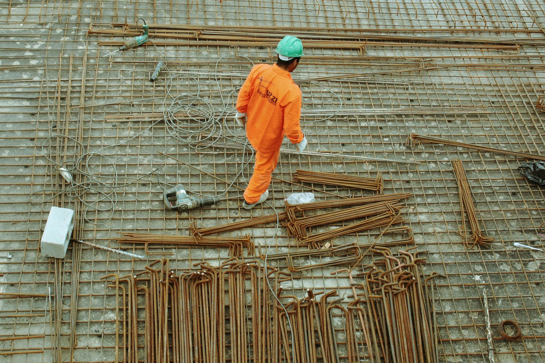 Engineer documenting reinforcing steel and slab conditions during a site investigation