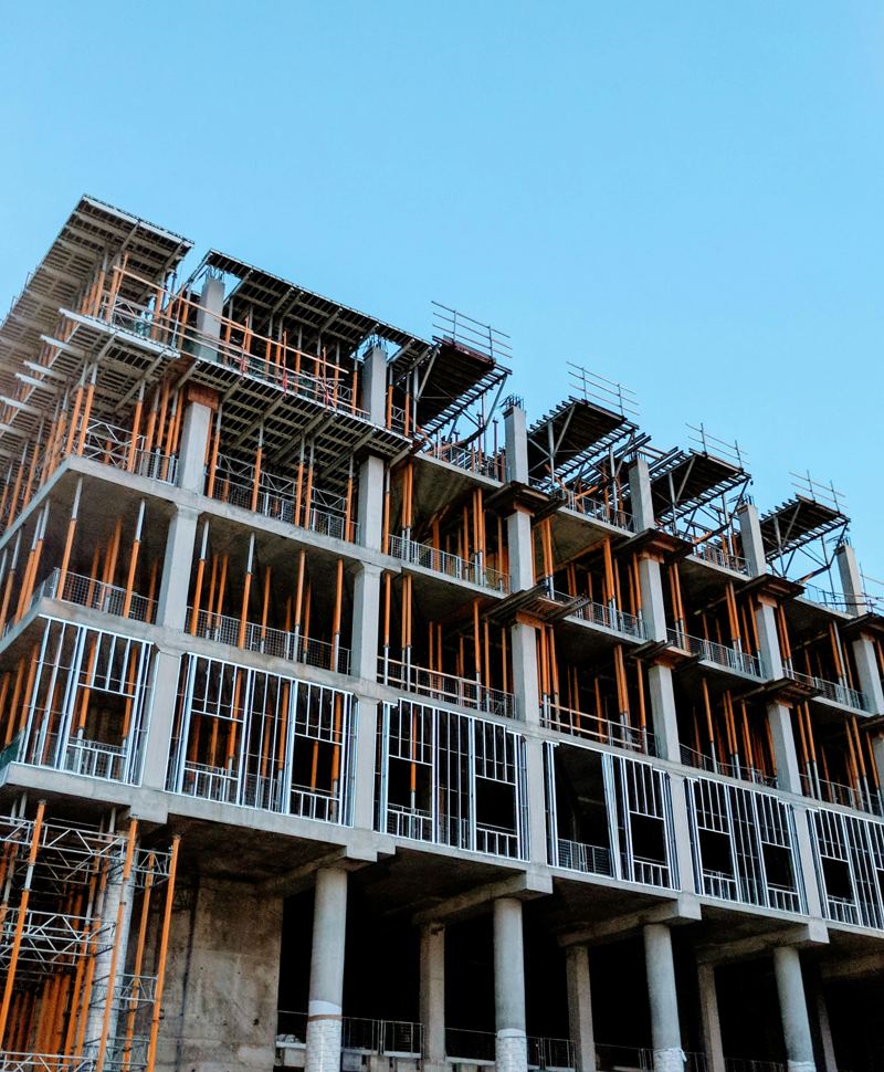 Existing concrete building under renovation with scaffolding and temporary shoring