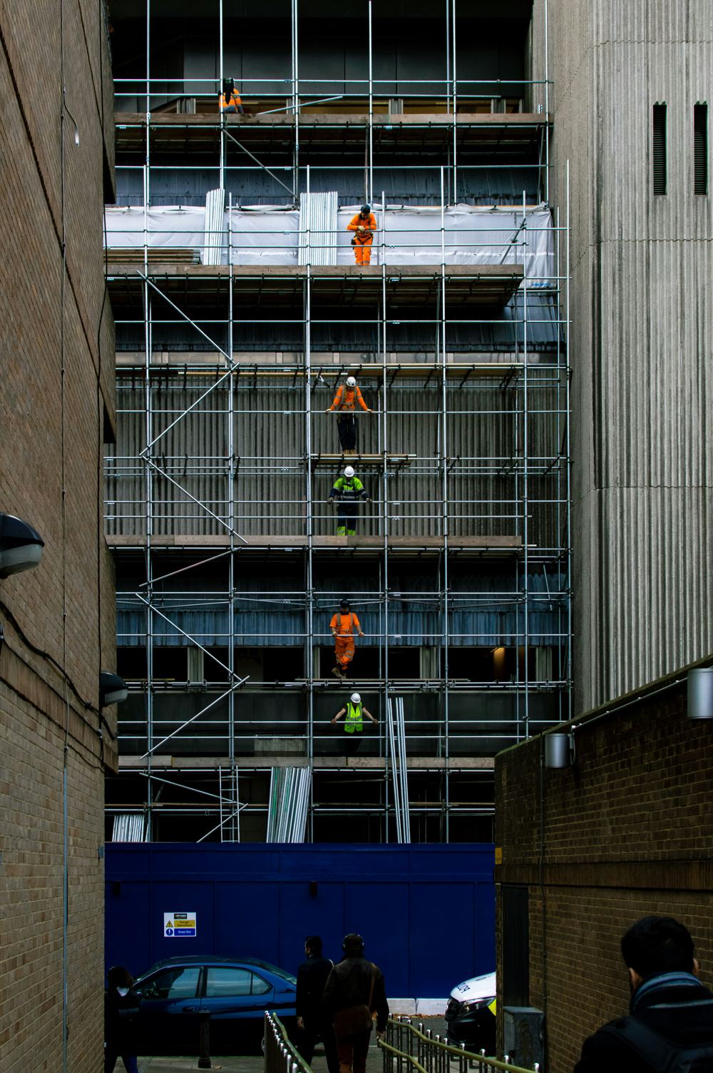 Crew working from scaffolding on a building facade during an envelope survey