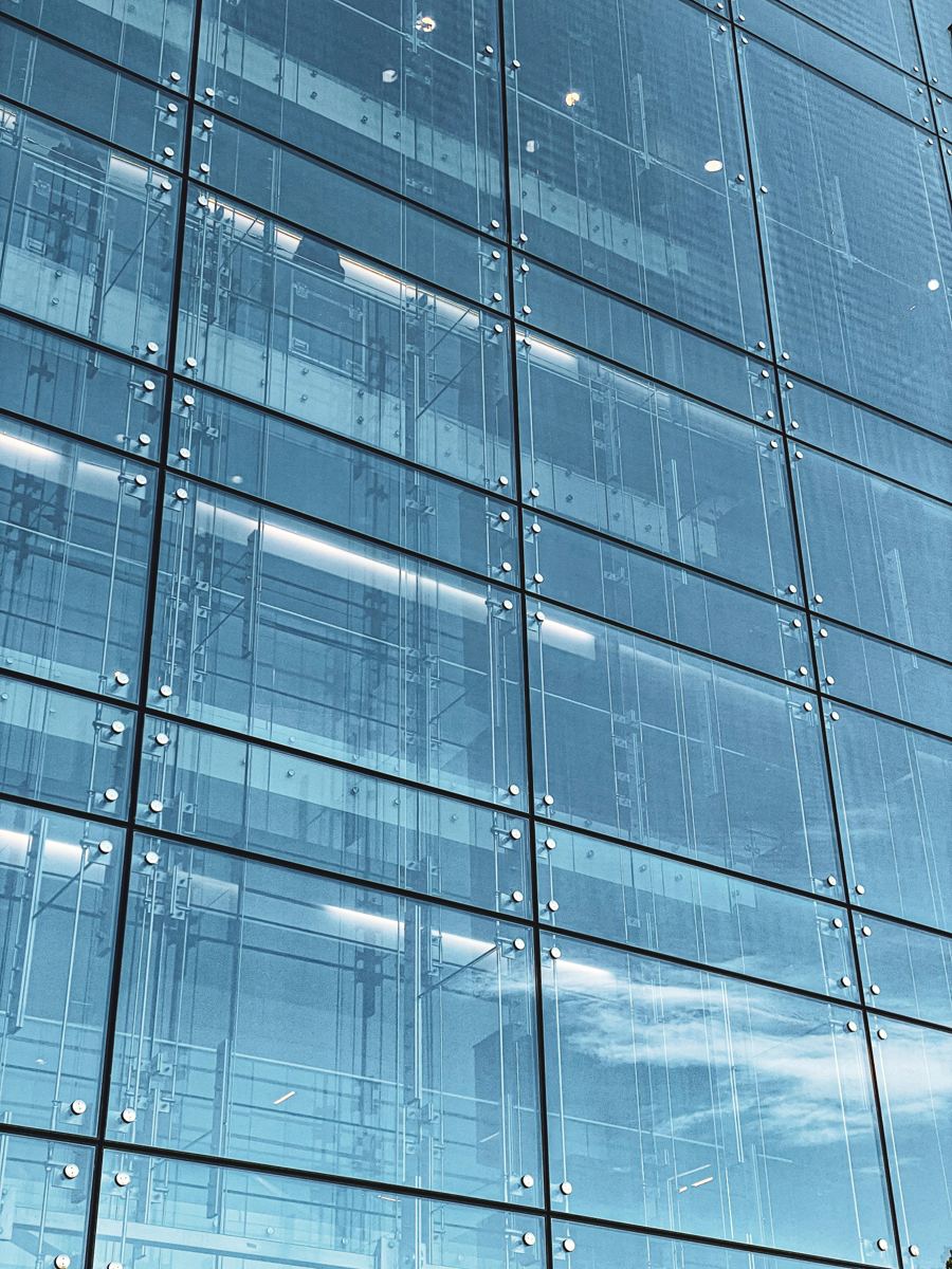 Close-up of a glass curtain wall with point-fixed structural glazing fittings