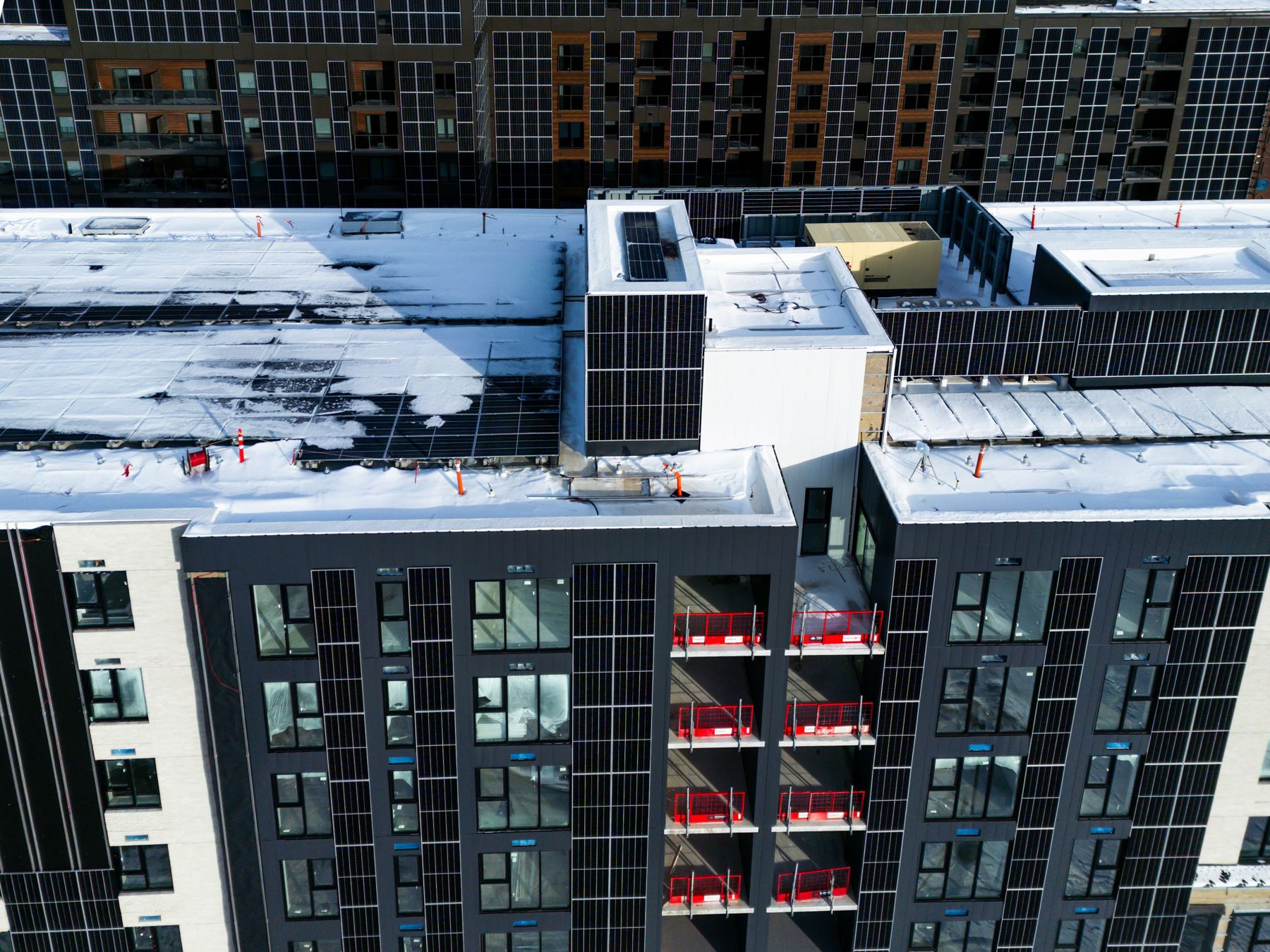 Rooftops with solar arrays viewed from above during a structural review
